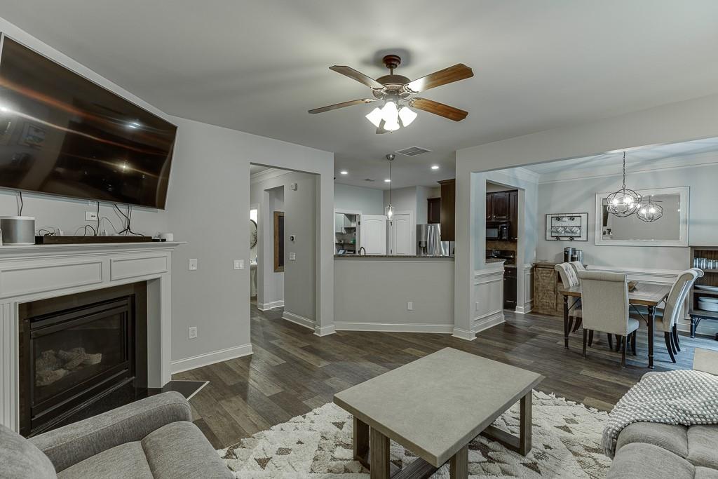 2140 Harvest Ridge Circle Northeast Buford, GA 30519 - Photo 16 of 38 a living room with furniture a flat screen tv and kitchen view
