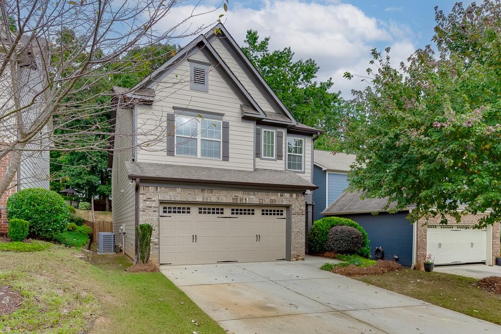 2140 Harvest Ridge Circle Northeast Buford, GA 30519 - Photo 2 of 38 a view of a house with a yard and plants