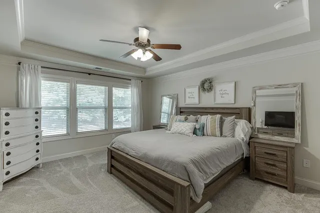 a bedroom with a large bed and a tv