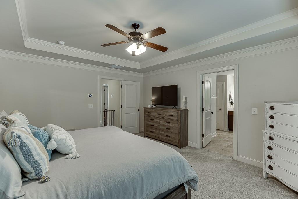 2140 Harvest Ridge Circle Northeast Buford, GA 30519 - Photo 23 of 38 a bedroom with a bed and a flat screen tv on the dresser