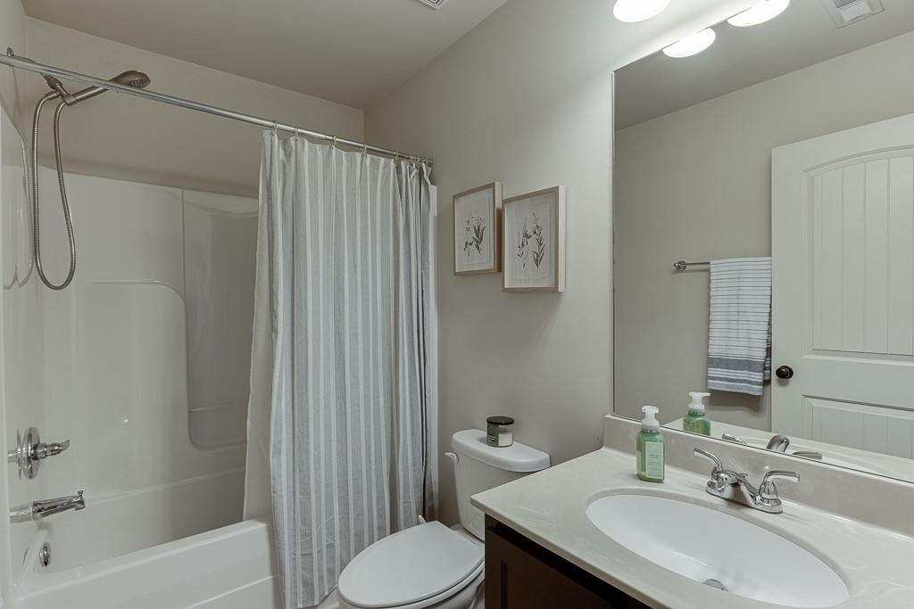 2140 Harvest Ridge Circle Northeast Buford, GA 30519 - Photo 30 of 38 a bathroom with a sink toilet and shower