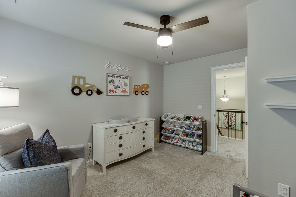 2140 Harvest Ridge Circle Northeast Buford, GA 30519 - Photo 32 of 38 a living room with furniture and a ceiling fan