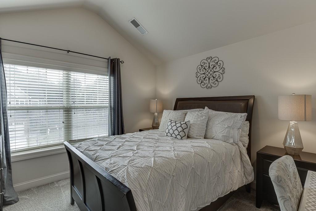 2140 Harvest Ridge Circle Northeast Buford, GA 30519 - Photo 33 of 38 a bedroom with a bed and a window