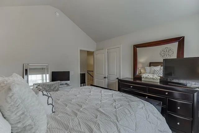 a bedroom with a bed and a television