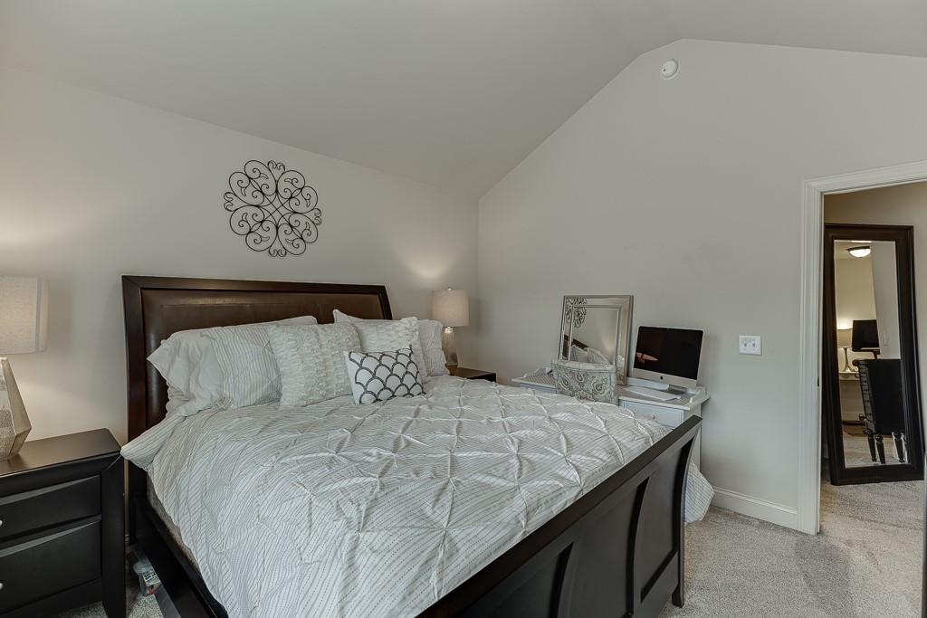2140 Harvest Ridge Circle Northeast Buford, GA 30519 - Photo 35 of 38 a bedroom with a bed and a table in it