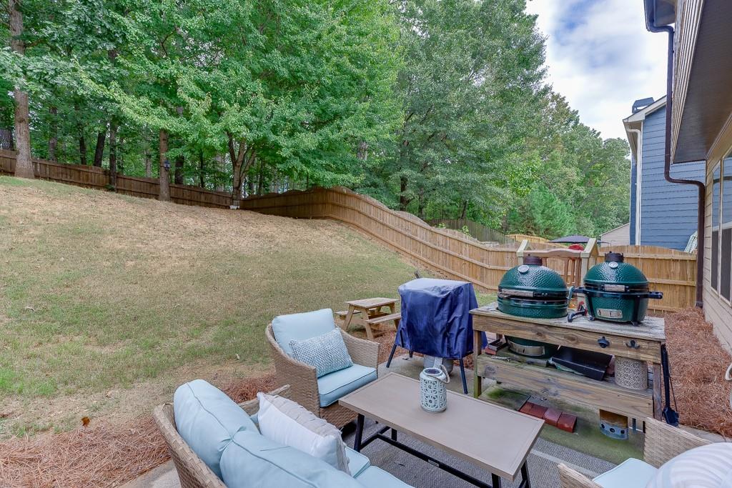 2140 Harvest Ridge Circle Northeast Buford, GA 30519 - Photo 36 of 38 a view of a patio with couple of chairs