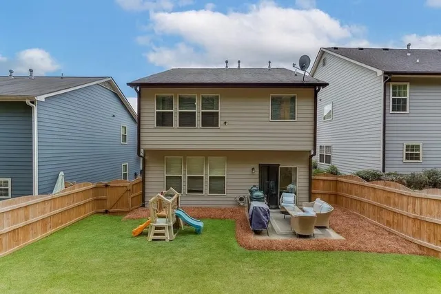 a view of a house with a backyard and a patio