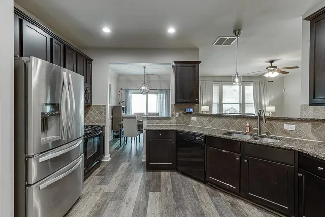 a kitchen with a sink stainless steel appliances and cabinets
