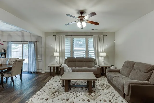 a living room with furniture and wooden floor