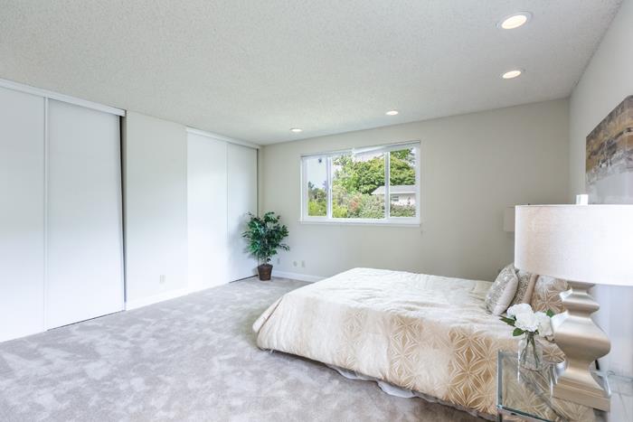 1324 Flicker Way Sunnyvale, CA 94087 - Photo 16 of 33 a bedroom with a large bed and a potted plant