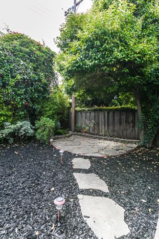 1324 Flicker Way Sunnyvale, CA 94087 - Photo 26 of 33 a view of a backyard with large trees and wooden fence