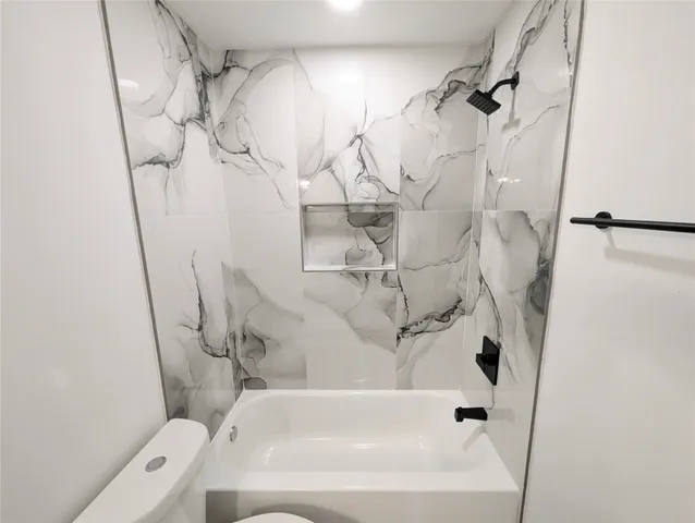 a bathroom with a bathtub and shower