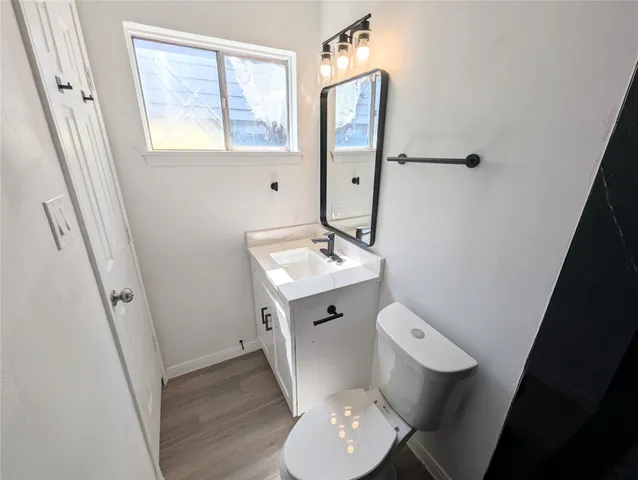 a white toilet sitting next to a bathroom sink