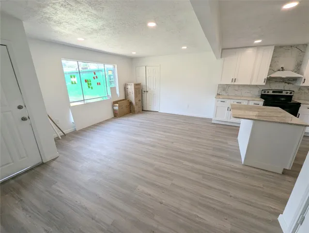 a view of kitchen with wooden floor and electronic appliances