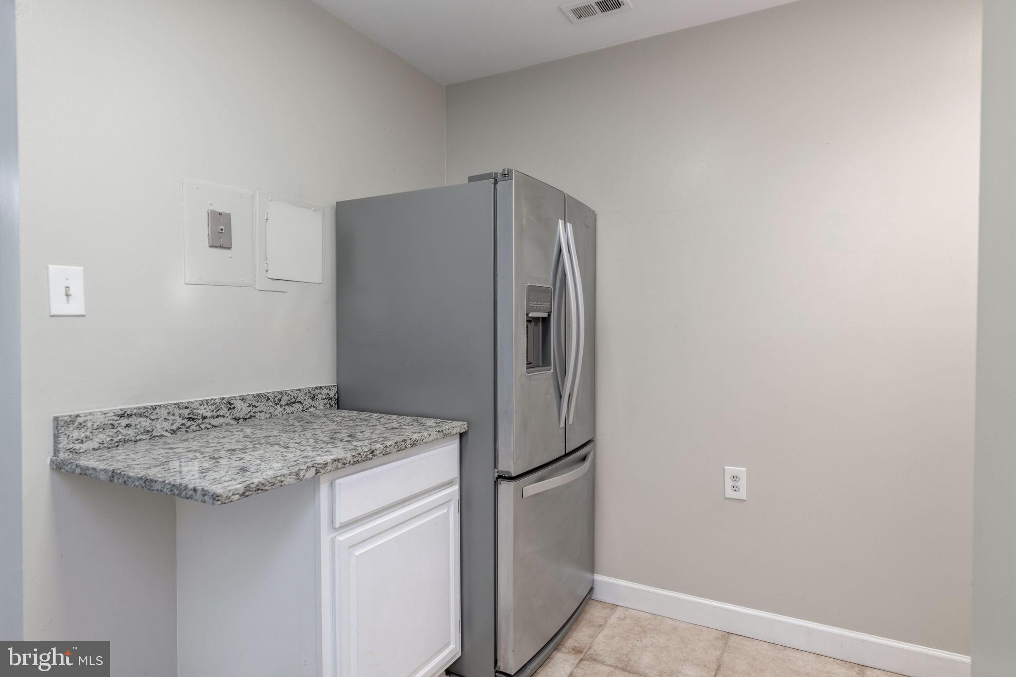 1443 Northgate Square, Unit 22B Reston, VA 20190 - Photo 11 of 42 a kitchen with a refrigerator and countertop