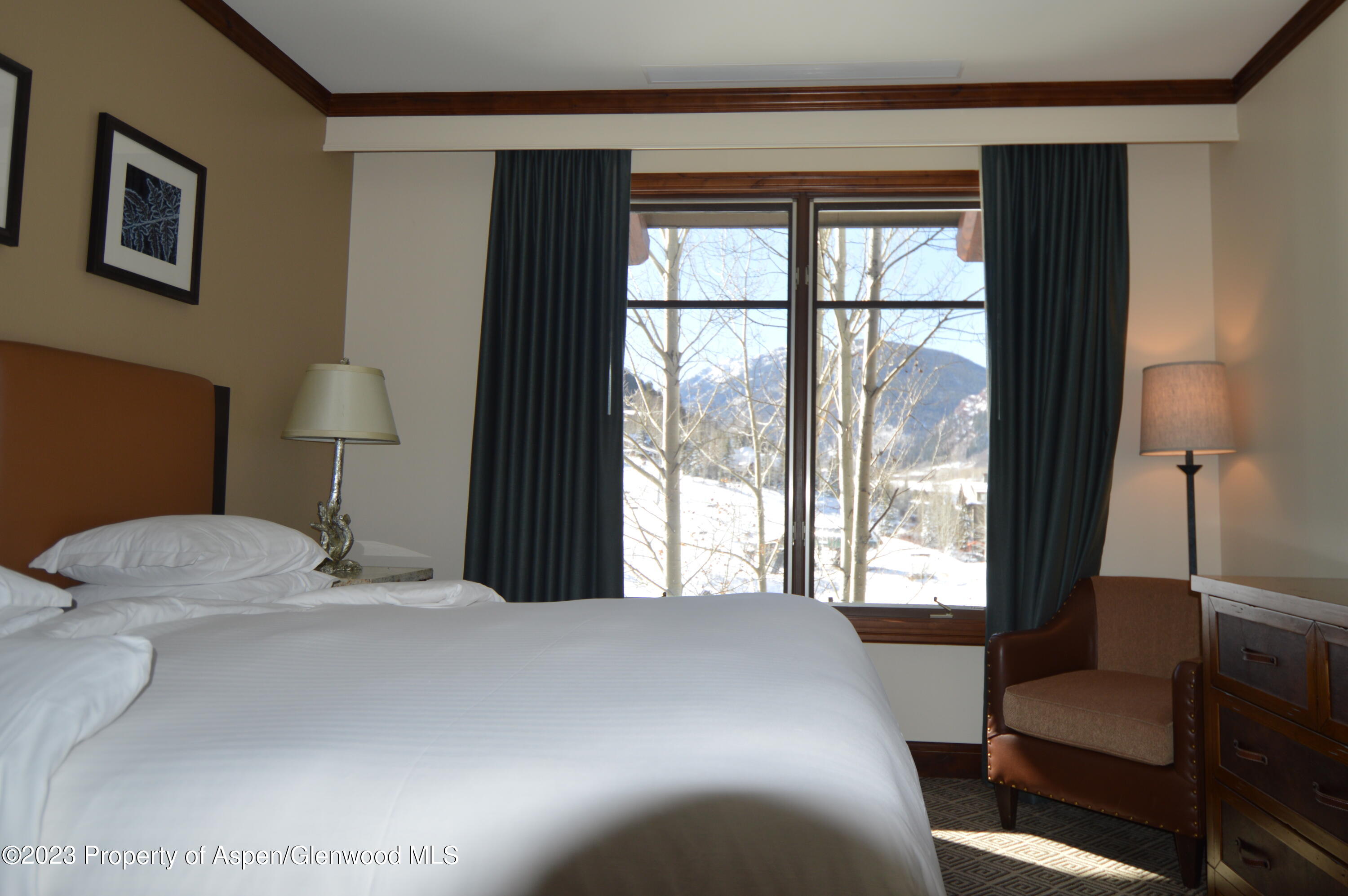 197 Prospector Road, Unit 2405 SUMMER INTEREST 12 Aspen, CO 81611 - Photo 14 of 24 a bedroom with a bed and a window