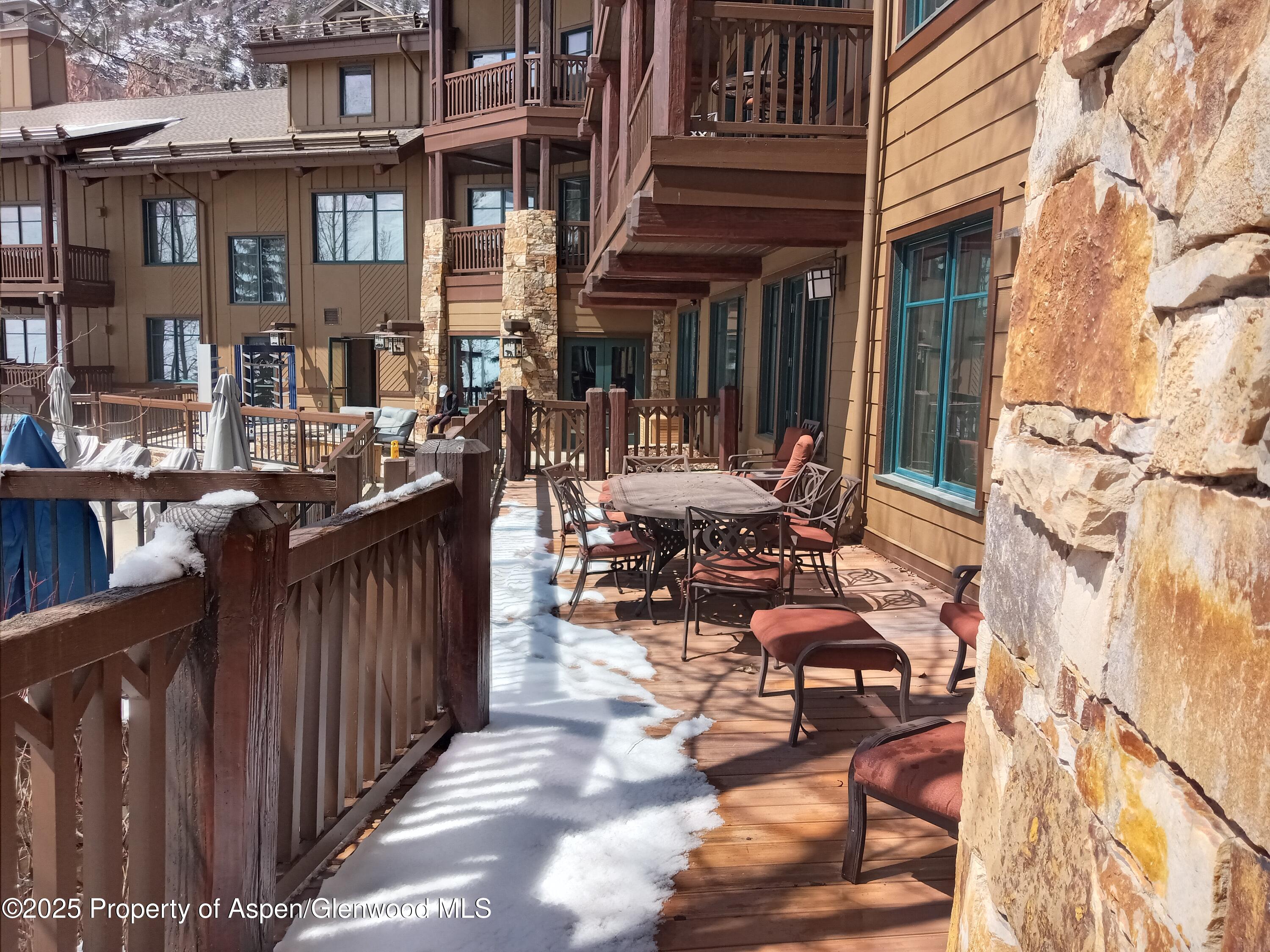 197 Prospector Road, Unit 2405 SUMMER INTEREST 12 Aspen, CO 81611 - Photo 17 of 24 a view of a patio with chairs and potted plants