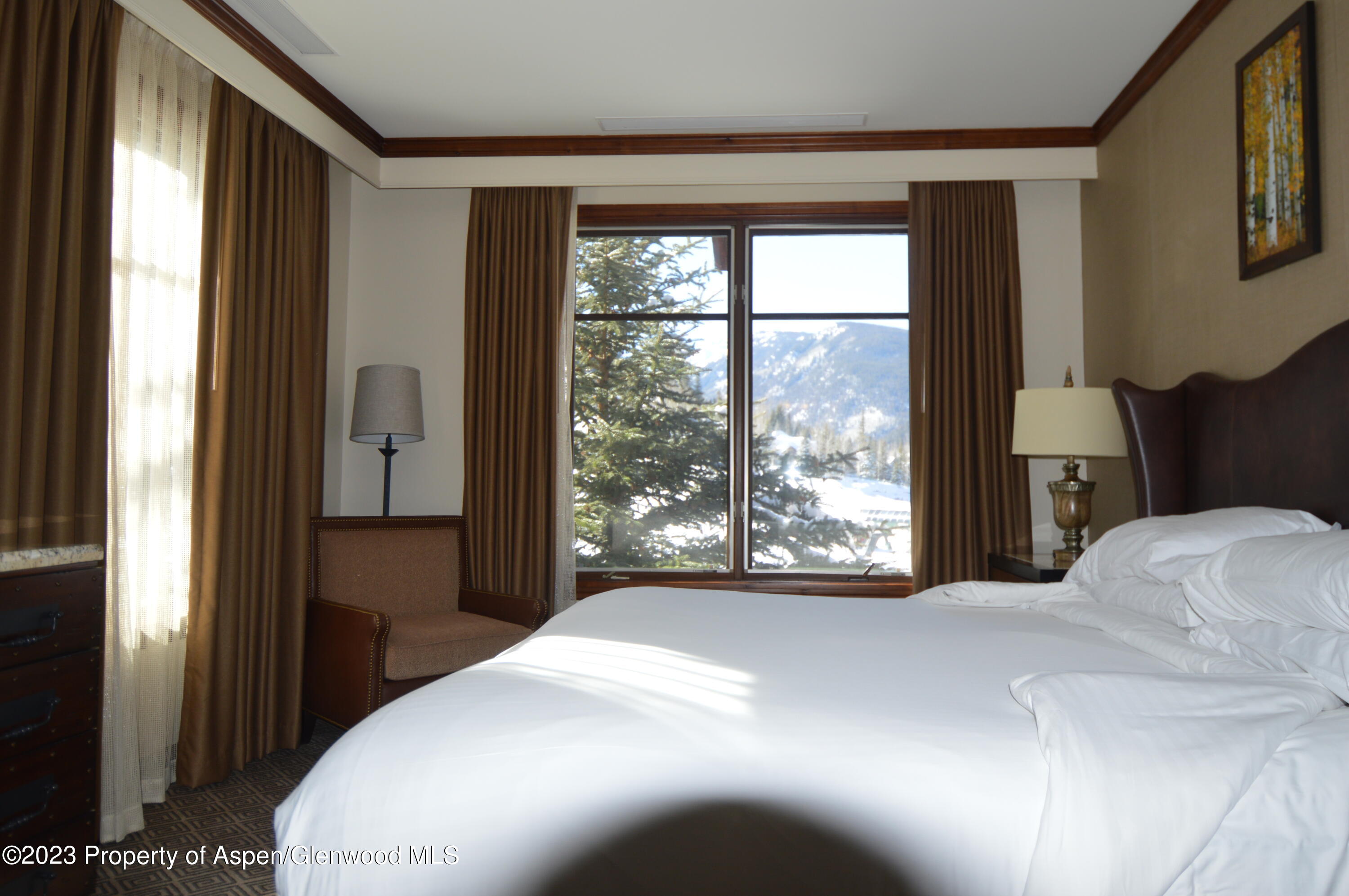 197 Prospector Road, Unit 2405 SUMMER INTEREST 12 Aspen, CO 81611 - Photo 8 of 24 a bedroom with a bed and a large window