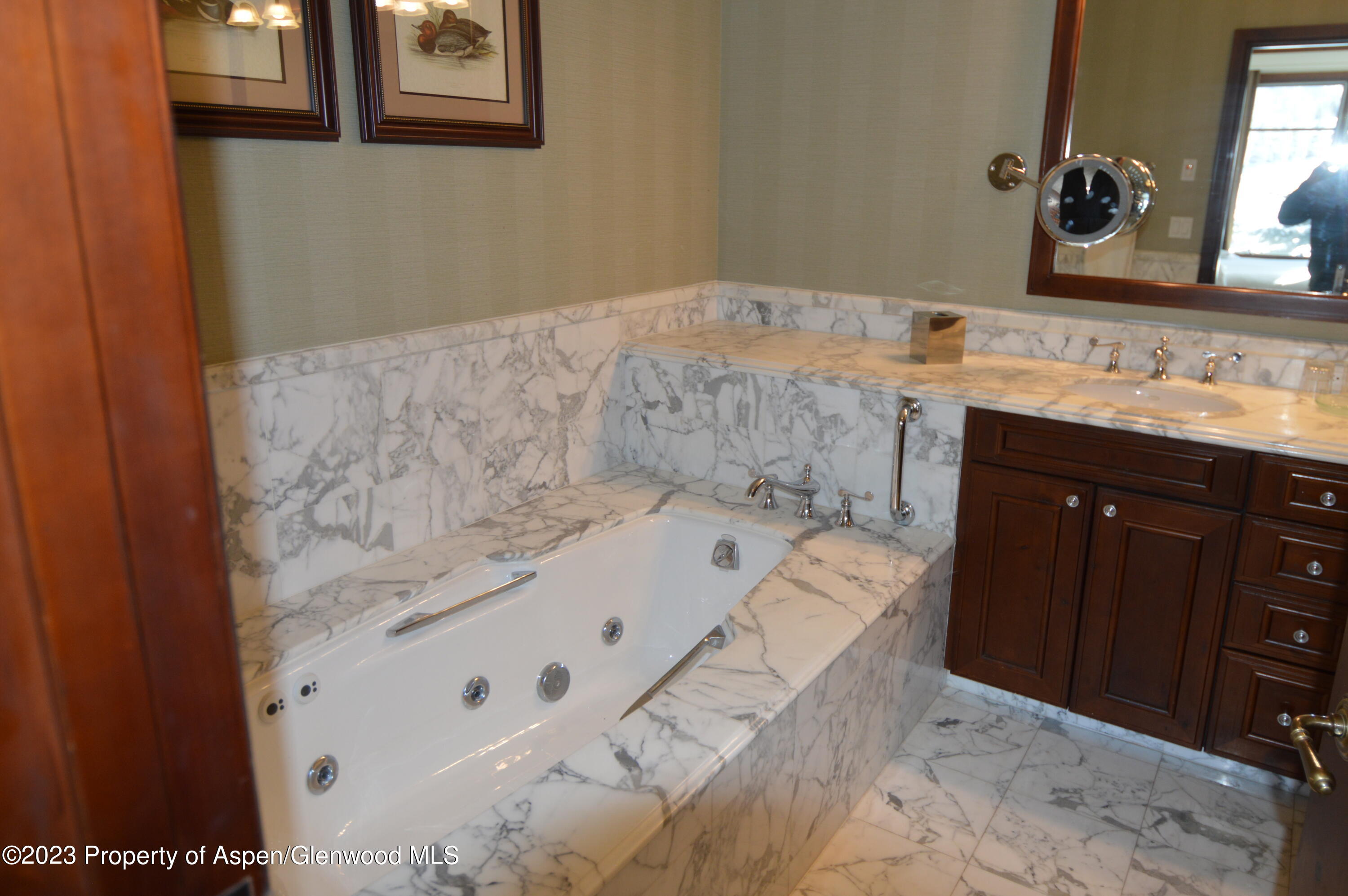 197 Prospector Road, Unit 2405 SUMMER INTEREST 12 Aspen, CO 81611 - Photo 10 of 24 a bathroom with a tub sink and mirror