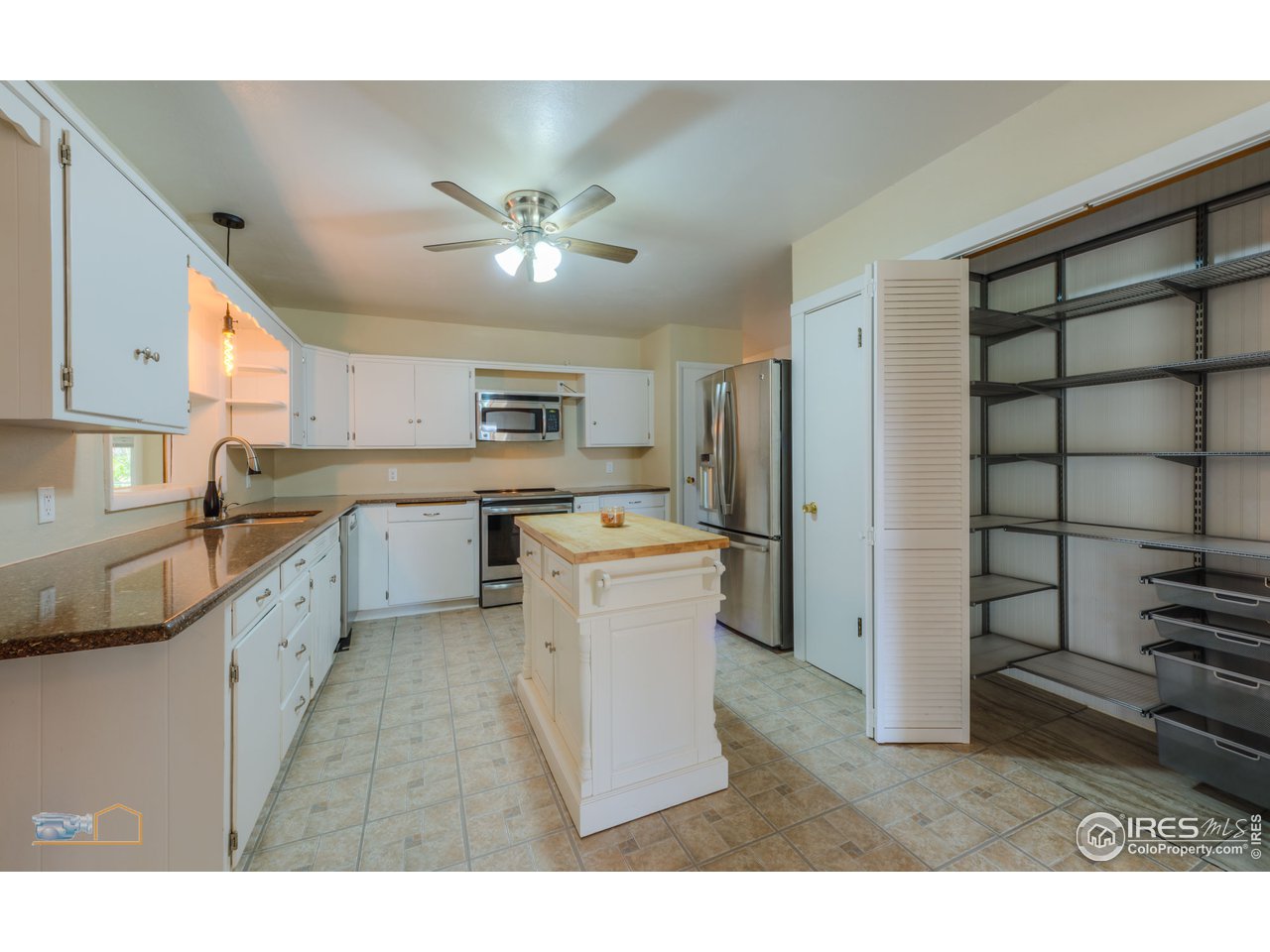8080 Hygiene Road Longmont, CO 80503 - Photo 31 of 40 a kitchen with a refrigerator and a sink