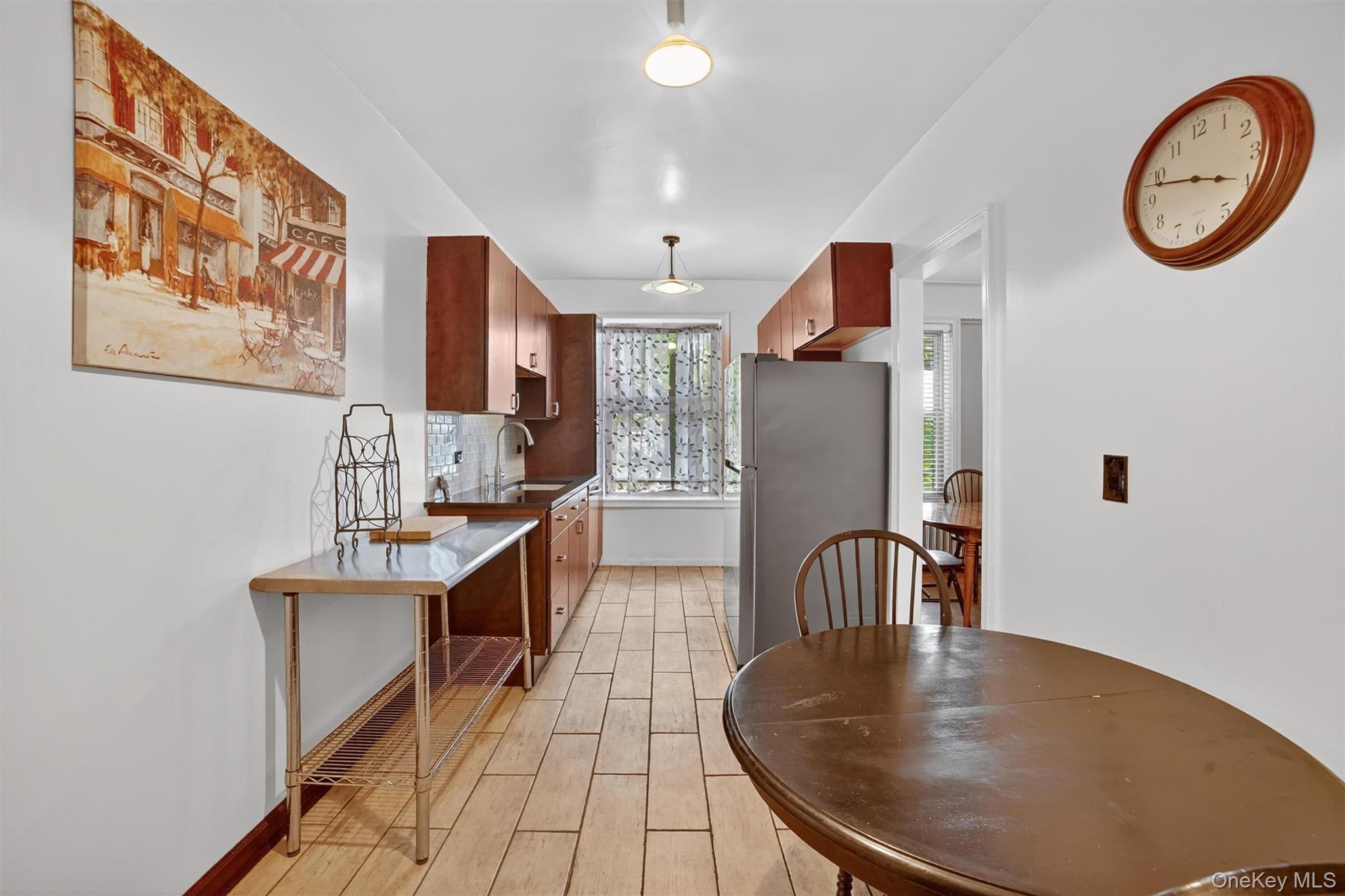 219 Bronx River Road, Unit 2L Yonkers, NY 10704 - Photo 13 of 29 a view of kitchen with furniture and a chandelier
