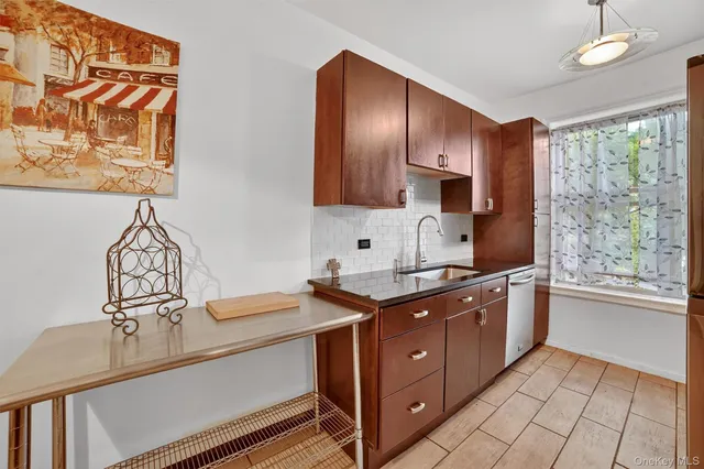 a kitchen with stainless steel appliances white cabinets and a stove top oven