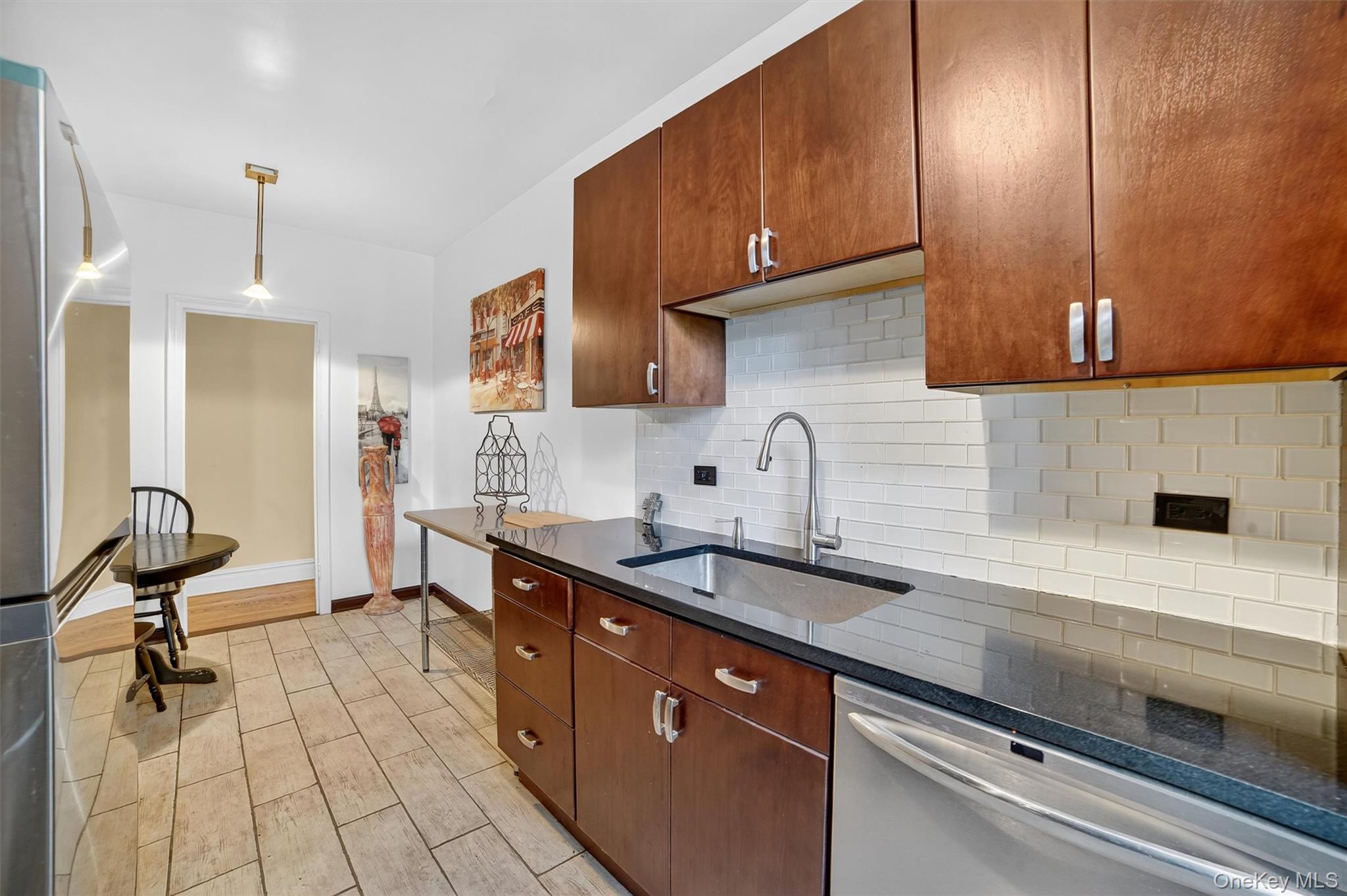 219 Bronx River Road, Unit 2L Yonkers, NY 10704 - Photo 17 of 29 a kitchen with granite countertop a sink stainless steel appliances and cabinets