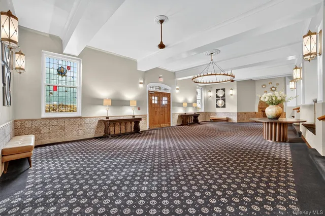 a living room with furniture and a chandelier
