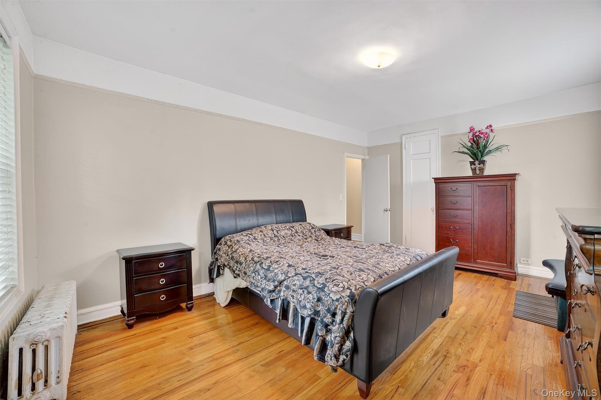 219 Bronx River Road, Unit 2L Yonkers, NY 10704 - Photo 22 of 29 a bedroom with a bed and a dresser
