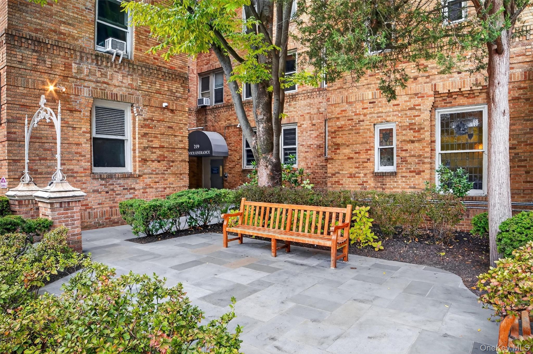 219 Bronx River Road, Unit 2L Yonkers, NY 10704 - Photo 28 of 29 a front view of a house with a garden