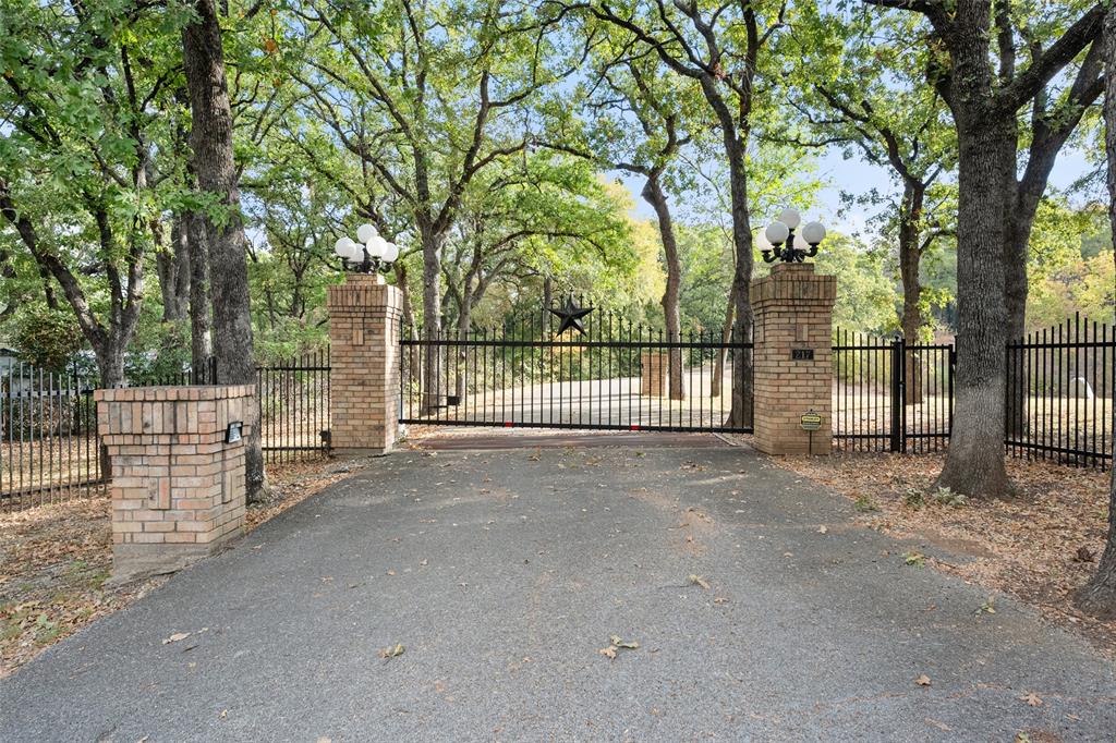 217 Williams Road Fort Worth, TX 76120 - Photo 2 of 36 A grand, gated entrance welcomes guests to this secluded estate