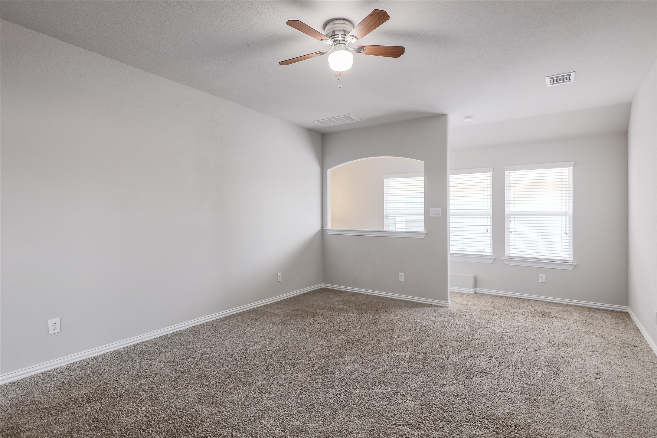 205 Penna Lane Georgetown, TX 78628 - Photo 22 of 32 A spacious secondary living area features soft carpet and bright windows, ready for personalization.