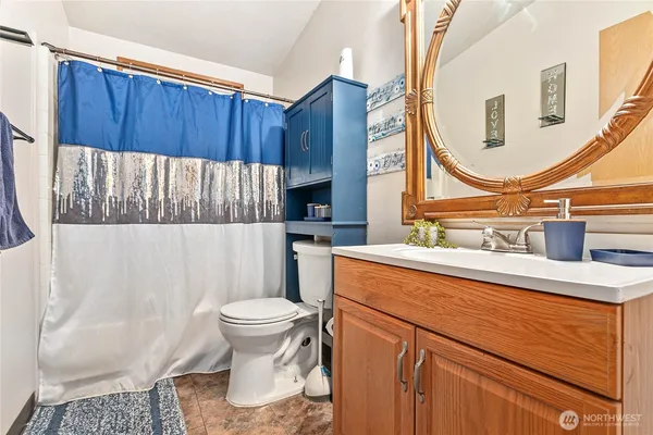 a bathroom with a sink a toilet and a mirror