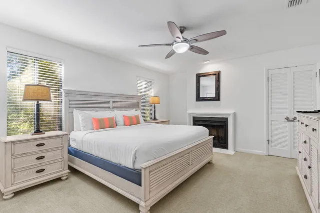 a bedroom with a bed and a ceiling fan