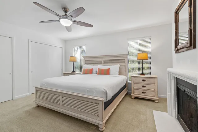 a bed room with a bed and a ceiling fan