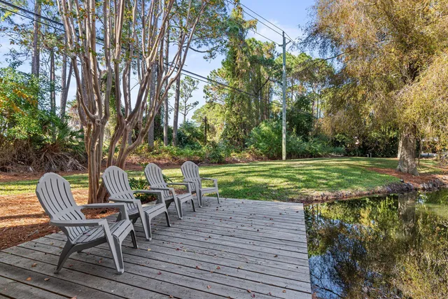 a view of a chairs and table on the wooden deck