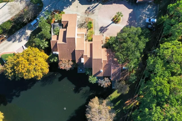 an aerial view of a house a yard and a lake view