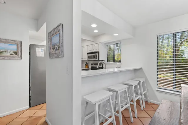 a kitchen with stainless steel appliances a refrigerator and microwave