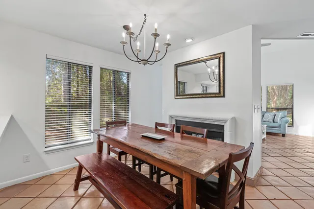a view of a dining room with furniture wooden floor and chandelier