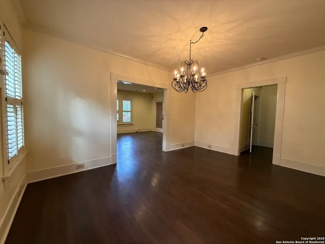 a view of a livingroom with wooden floor and a large window