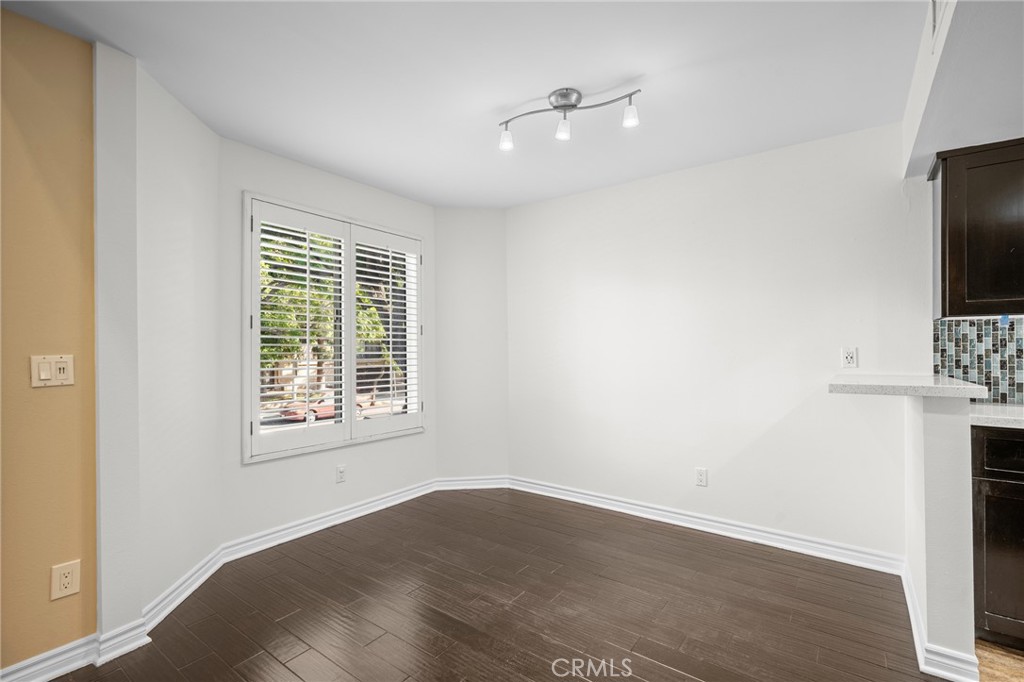 323 North Jackson Street, Unit 119 Glendale, CA 91206 - Photo 11 of 34 an empty room with wooden floor and windows