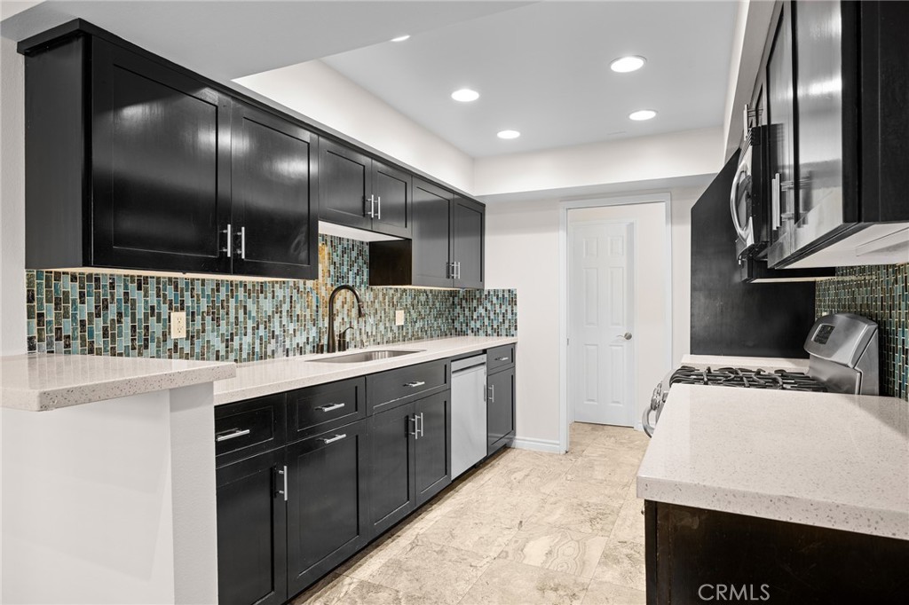 323 North Jackson Street, Unit 119 Glendale, CA 91206 - Photo 12 of 34 a kitchen with stainless steel appliances granite countertop a sink and a stove