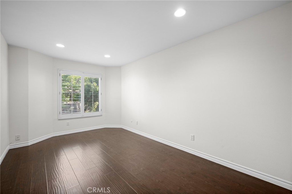 323 North Jackson Street, Unit 119 Glendale, CA 91206 - Photo 18 of 34 an empty room with wooden floor and windows