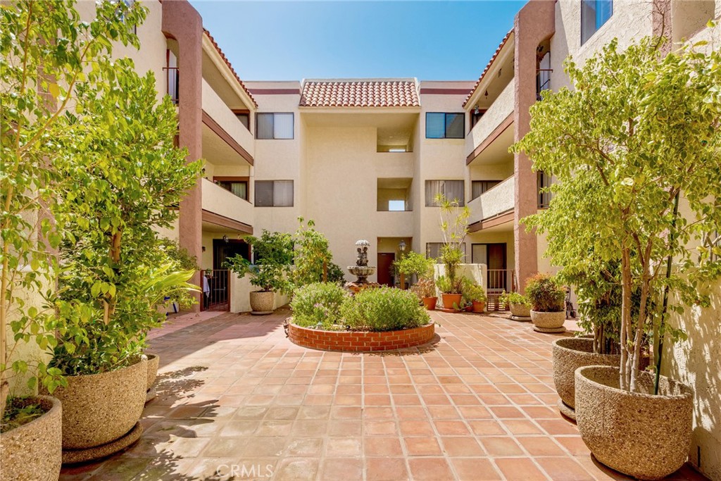 323 North Jackson Street, Unit 119 Glendale, CA 91206 - Photo 33 of 34 a front view of a house with a yard