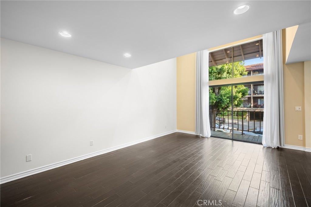 323 North Jackson Street, Unit 119 Glendale, CA 91206 - Photo 5 of 34 an empty room with wooden floor and windows