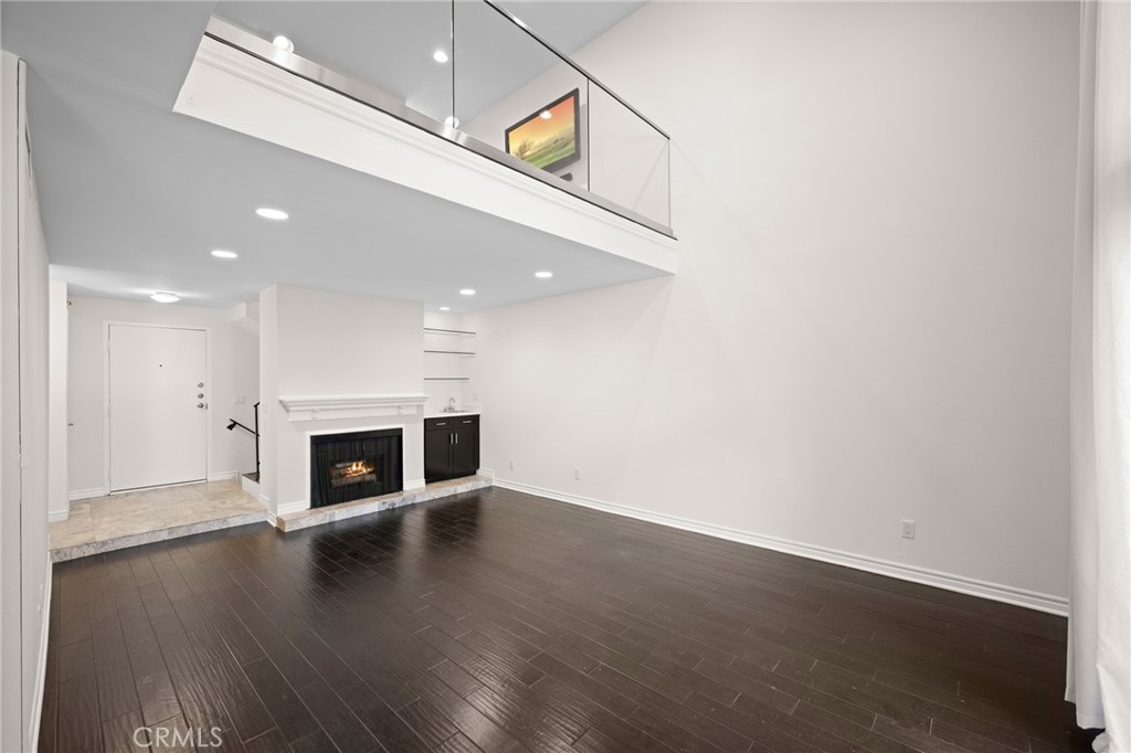 323 North Jackson Street, Unit 119 Glendale, CA 91206 - Photo 6 of 34 an entryway with wooden floor fire place and windows