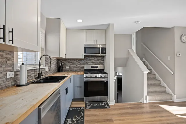 a kitchen with a sink stove and refrigerator