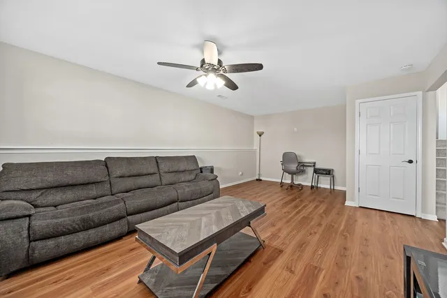 a living room with furniture and wooden floor