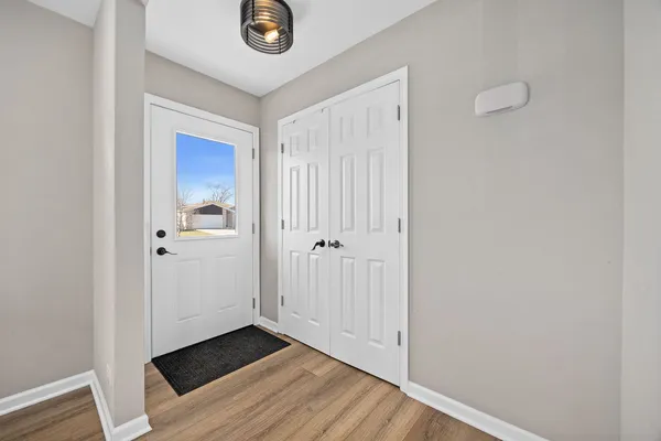 a view of a hallway with wooden floor