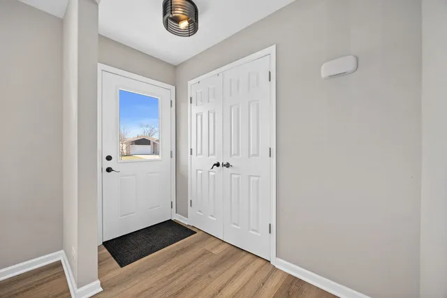 a view of a hallway with wooden floor